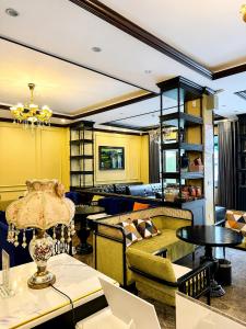 a restaurant with yellow walls and tables and chairs at Aurora Hotel SaPa in Sapa +27 photos