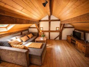 a large living room with a couch and a tv at Torwärterhaus Kipfenberg-Arnsberg in Arnsberg