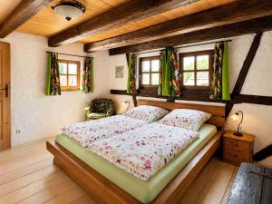 a bedroom with a bed in a room with windows at Torwärterhaus Kipfenberg-Arnsberg in Arnsberg