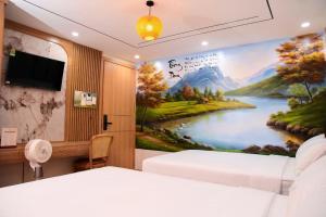 a bedroom with a painting of a river at Thong Dong homestay&villas in Ninh Binh