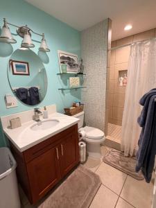a bathroom with a sink and a toilet and a shower at Laie Temple Hale in Laie