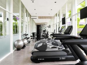 a gym with rows of treadmills and exercise bikes at Mercure Serpong Alam Sutera in Serpong