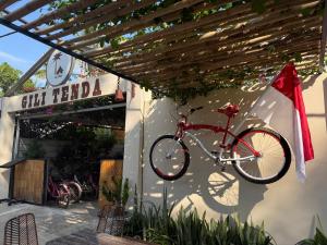 a bike is hanging on the side of a building at Gili Tenda in Gili Trawangan