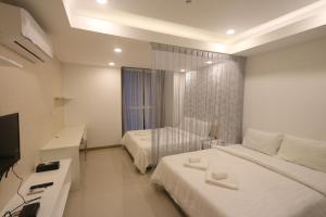 Postel nebo postele na pokoji v ubytování CA&SA Serviced Apartment