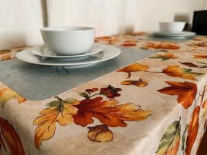 a table with a table cloth with a coffee cup on it at Charming And Cozy Studio In Oleander Sunset in Bakersfield