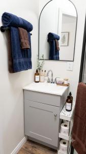 a bathroom with a sink and a mirror at Charming And Cozy Studio In Oleander Sunset in Bakersfield