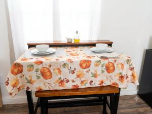 a table with a table cloth with two cups on it at Charming And Cozy Studio In Oleander Sunset in Bakersfield