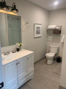 a white bathroom with a toilet and a sink at Burk Fall view 3B3B in Burks Falls +29 photos