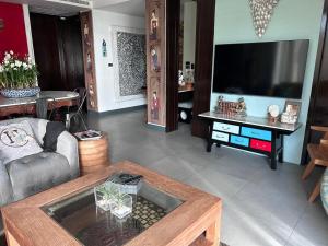 a living room with a large flat screen tv at Karon Beach Stunning 2 bed apt unit 700 in Karon Beach