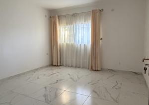 a white room with a marble floor and a window at Mountain Escape with Rooftop in Jūrat Arşūn