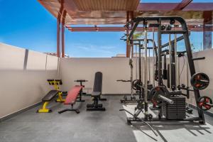 a gym with exercise equipment on a roof at XHOME Danang Hotel & Suite - Near My Khe Beach in Danang