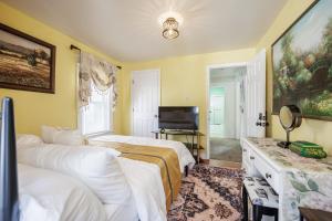 a bedroom with two beds and a flat screen tv at Room B3 Shared bathroom queen bed privacy balcony in Rochester