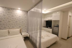 Postel nebo postele na pokoji v ubytování CA&SA Serviced Apartment