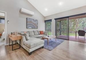 a living room with a couch and a table at #4 Riverspa in Moama