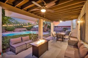 a patio with a couch and a table and a pool at Sparkling SaltwtrPoolSpaFirepitFreeNetflixWiFi in Phoenix