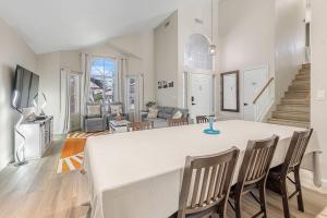 a dining room and living room with a table and chairs at Sparkling SaltwtrPoolSpaFirepitFreeNetflixWiFi in Phoenix