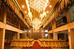a large room with chairs and a chandelier at Greenmont Hotel & Apartment in Bandar Seri Begawan