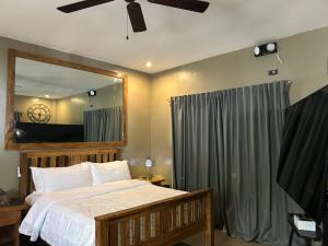 a bedroom with a bed and a large mirror at Txaleta de Camiguin desde 2024 in Mambajao