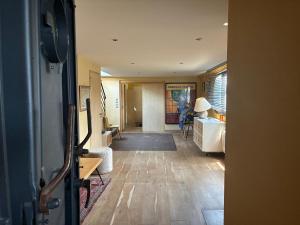 a hallway of a house with a room with a table at Peniche Casa Luze in Issy-les-Moulineaux