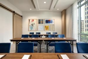 a conference room with a large table and blue chairs at Holiday Inn Express Houston Downtown by IHG in Houston +104 photos