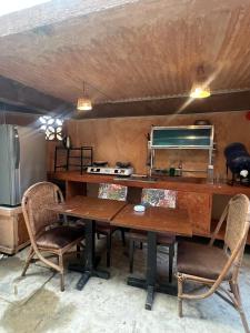a kitchen with a wooden table and chairs at Kundiman Siargao, General Luna in General Luna