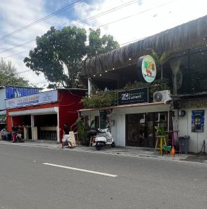 a man walking down a street in front of a store at Kundiman Siargao, General Luna in General Luna +9 photos