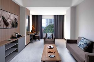 a living room with a couch and a table at Oakwood Merdeka Bandung in Bandung