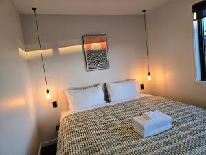 a bedroom with a bed with two towels on it at Simply Stunning Stars A in Lake Tekapo