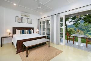 a bedroom with a bed and a large window at Villa Lé Maas Tota by 98 Acres in Koslanda +53 photos