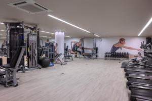 a gym with people working out in it at Meliá Lisboa Aeroporto in Lisbon