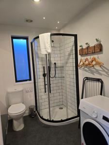 a bathroom with a shower and a toilet at Simply Stunning Stars B in Lake Tekapo
