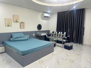a bedroom with a bed and a living room at Flower Apartment in Buôn Enao