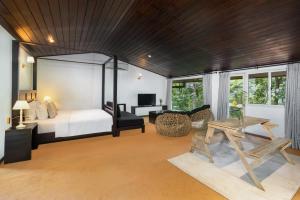 a bedroom with a bed and a desk and a table at Villa Lé Maas Tota by 98 Acres in Koslanda