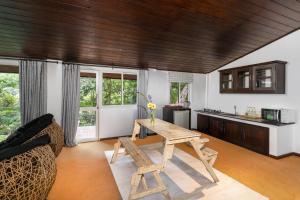 a living room with a table and a kitchen at Villa Lé Maas Tota by 98 Acres in Koslanda