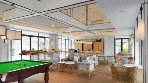 a living room with a pool table in it at Meliá Koh Samui in Choeng Mon Beach
