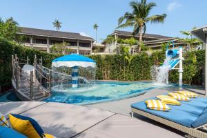 a pool with a water slide in a resort at Meliá Koh Samui in Choeng Mon Beach