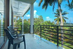 a balcony with two chairs and a view of the forest at Tranquil Heaven Near Galle & Unawatuna Quiet Stay & Fast WiFi in Galle