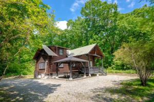 a log cabin in the woods with a gravel driveway at COTTAGE SaY in Nasushiobara