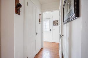 a hallway with a white door and a television at B4Garden Suite Shared bathroom QBed washer dryer in Rochester