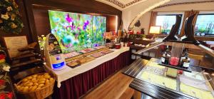 a bakery with a counter with a fish tank at Hotel Rossmann in Greifenburg