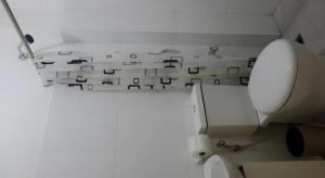 a white bathroom with a toilet and a wall withwords at Hotel Monde in Dagupan +98 photos