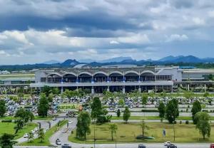 a large building with a parking lot in front of it at Point Stay GH in Kuching