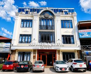 a building with cars parked in front of it at Aurora Hotel SaPa in Sapa