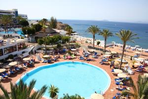 an overhead view of a swimming pool and the beach at Sandos Papagayo in Playa Blanca