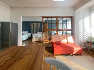 a living room with a table and a refrigerator at El Martín Pescador in Osorno