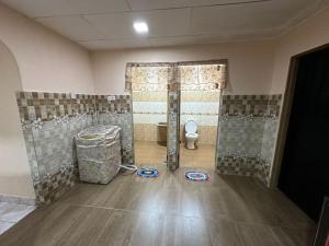 a bathroom with a toilet in a room at Kannan homestay in Kamunting