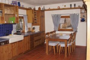 a kitchen with a table and chairs and a sink at Ferienhaus am Wallnerhof in Flattach