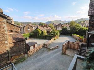 a view of a town with houses and a bench at Kelsick Heights in Ambleside