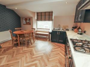 a kitchen and dining room with a wooden floor at Kelsick Heights in Ambleside