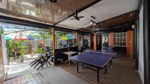 a ping pong table in the middle of a room at Finimas Residence in Thimarafushi